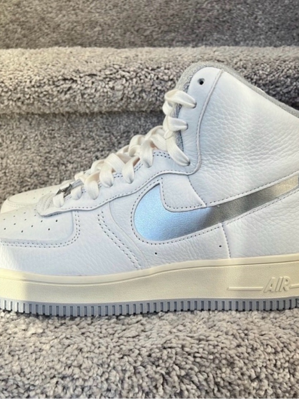 Nike White High-Top Sneakers with Metallic Silver Swoosh